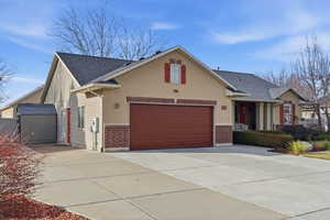 Traditional-style house with brick siding, concrete driveway, and a shingled roof