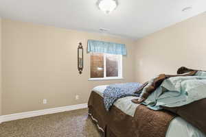 Carpeted bedroom featuring baseboards