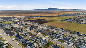 Aerial view of property and surrounding area with nearby suburban area