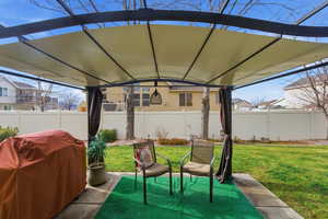 Fenced backyard with grilling area and a patio area