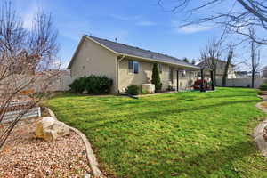 Back of house with a fenced backyard, a patio, and a shingled roof