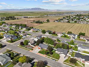 Overview of rural landscape featuring nearby suburban area and a mountain backdrop