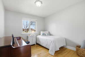 Bedroom featuring light wood-type flooring and baseboards