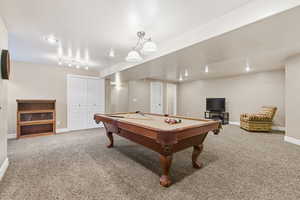 Game room with light carpet and pool table