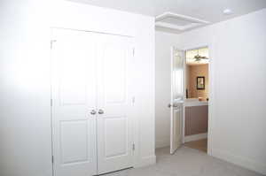 Unfurnished bedroom with light colored carpet and a closet