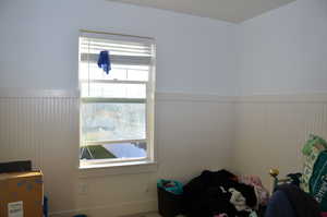 Bedroom with a wainscoted wall
