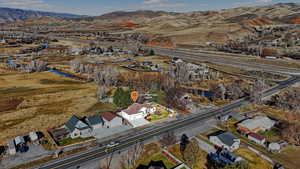 Aerial overview of property's location featuring a mountainous background and nearby suburban area