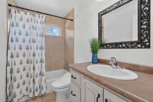 Full bathroom featuring shower / bath combo, vanity, and light tile  flooring