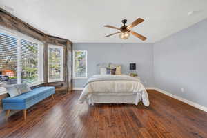 Bedroom featuring a ceiling fan and dark wood-style floors