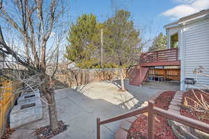 Fenced backyard with a patio area and stairs