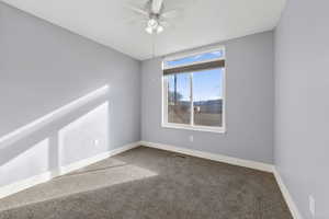 bedroom #2 room with new carpet floors and a ceiling fan