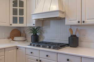 Kitchen with white cabinetry and light countertops