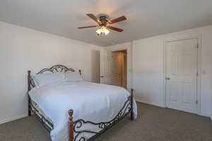 Bedroom featuring carpet flooring, ceiling fan, and a textured ceiling