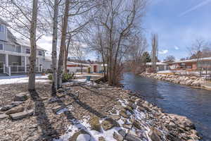 View of yard with a residential view, a water view, and an outbuilding