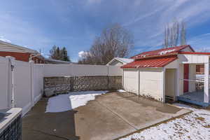 Snow covered patio with a patio area