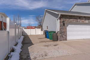 View of property exterior with stone siding
