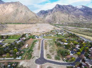 Aerial view of property and surrounding area featuring a mountainous background