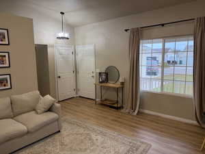 Sitting room featuring lofted ceiling and light wood-style flooring