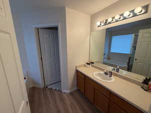 Full bathroom featuring a garden tub, vanity, dark wood-type flooring, and a stall shower