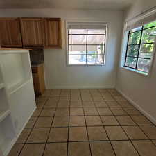 Unfurnished dining area featuring light tile patterned floors and a textured ceiling