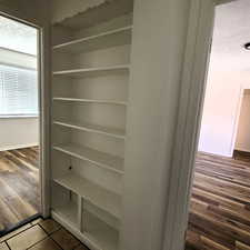 East unit View of hallway built in shelves