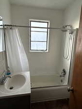 West upstairs full Bathroom with vanity, shower / bathtub combination with curtain, and plenty of natural light