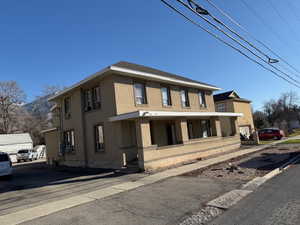 View of front of home with stucco siding and covered porch