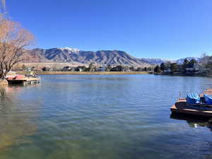 Dock featuring a water and mountain view