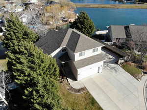 Aerial view of residential area featuring a nearby body of water