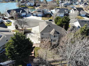 Aerial view of residential area featuring a nearby body of water
