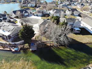 Aerial view of residential area featuring a nearby body of water