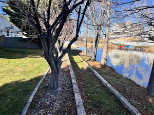 View of green lawn with a water view