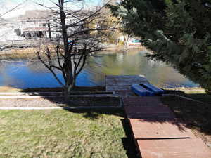 Dock featuring a water view and a yard