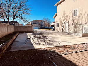 Fenced backyard with a patio area and outdoor dining area
