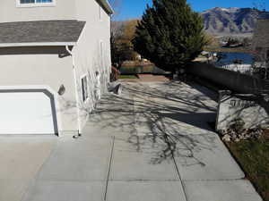 View of side of property with stucco siding and a shingled roof