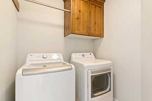 Washroom with washing machine and dryer and cabinet space