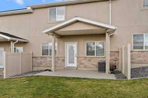 Entrance to property featuring stucco siding and stone siding