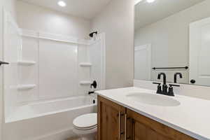 Full bath featuring vanity and  shower combination