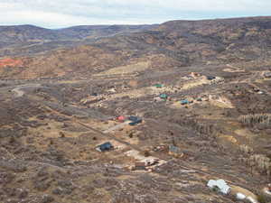 Aerial view of property's location featuring a mountainous background and rural landscape