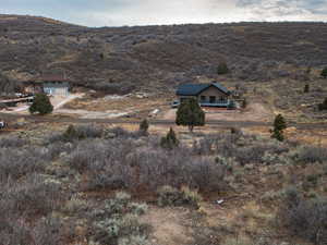 Aerial overview of property's location with rural landscape and a mountainous background