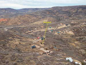 Aerial overview of property's location with mountains and rural landscape