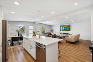 Island has dishwasher and sink, as well as extra seating