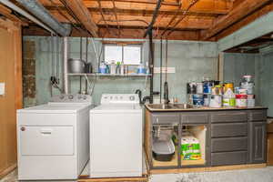 Washroom featuring washing machine and dryer and concrete flooring
