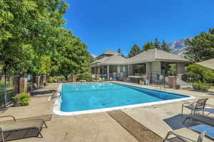 Community pool with a patio and a mountain view