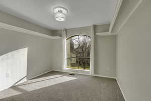 Unfurnished room featuring carpet and shelf