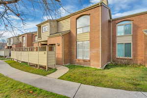 View of front facade with brick siding and a residential view