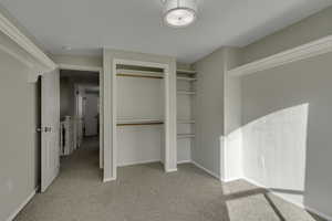 Unfurnished bedroom with a closet and light carpet