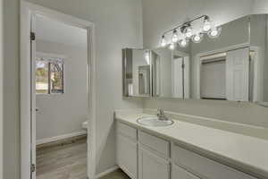 Primary bathroom with vanity and light wood-type flooring
