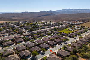 Aerial view of property and surrounding area with a mountainous background