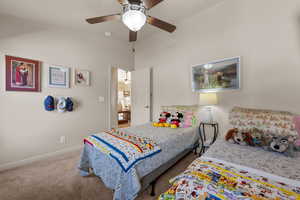 Carpeted bedroom featuring ceiling fan and baseboards